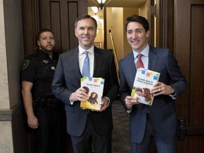 Prime Minister Justin Trudeau and Minister of Finance Bill Morneau arrive in the Foyer of the House of Commons to table the federal budget on Parliament Hill in Ottawa on Tuesday, March 19, 2019.