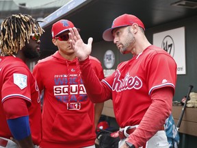 Philadelphia Phillies center fielder Odubel Herrera, left, and Philadelphia Phillies manager Gabe Kapler, right, talk in the dugout in the fourth inning during an exhibition spring training baseball game against the St. Louis Cardinals on Monday, March 18, 2019, in Jupiter, Fla.