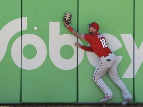 Philadelphia Phillies right fielder Lane Adams (18) can't get to a double hit by Toronto Blue Jays' Rowdy Tellez during the second inning of a spring training baseball game Wednesday, March 6, 2019, in Dunedin, Fla.