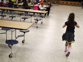 A student walks past empty seats in the Northside Elementary School cafeteria during lunchtime in Panama City, Fla, Thursday, Jan. 24, 2019. The county's student population has decreased by 14 percent since the storm, with some schools down by more than 40 percent.