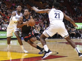 Miami Heat guard Dion Waiters drives past Brooklyn Nets guards Caris LeVert and Treveon Graham during the first half of an NBA basketball game at the American Airlines Arena Saturday, March 2, 2019 in Miami.