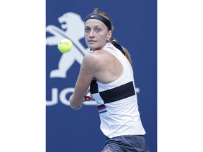 Petra Kvitova, of the Czech Republic, returns a volley to Caroline Garcia, of France, during the Miami Open tennis tournament, Monday, March 25, 2019, in Miami Gardens, Fla.