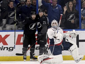 Tampa Bay Lightning Tyler Johnson (9) and Brayden Point (21) celebrate Johnson's first period goal as Washington Capitals goaltender Braden Holtby (70) watches the replay during an NHL hockey game Saturday, March 16, 2019, in Tampa, Fla.