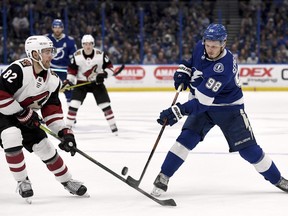 Arizona Coyotes defenseman Jordan Oesterle (82) stops a shot from Tampa Bay Lightning defenseman Mikhail Sergachev (98) during the second period of an NHL hockey game Monday, March 18, 2019, in Tampa, Fla.