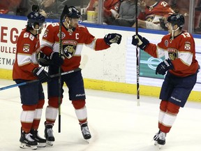 Florida Panthers' Aleksander Barkov, center, celebrates with teammates Mike Hoffman (68) and Mark Pysyk (13) after scoring a goal against the Ottawa Senators during the first period of an NHL hockey game, Sunday, March 3, 2019, in Sunrise, Fla.