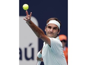 Roger Federer, of Switzerland, serves to John Isner during the singles final of the Miami Open tennis tournament, Sunday, March 31, 2019, in Miami Gardens, Fla.