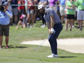 Dustin Johnson chips on the first green during the final round of the Valspar Championship golf tournament Sunday, March 24, 2019, in Palm Harbor, Fla.