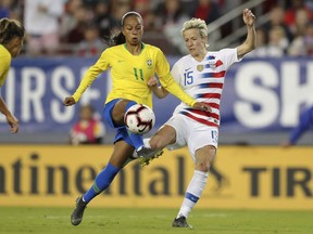 Brazil's Adriana and United States' Megan Rapinoe battle for a loose ball during the first half of a SheBelieves Cup soccer match Tuesday, March 5, 2019, in Tampa, Fla.