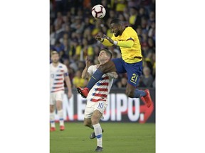 United States midfielder Christian Pulisic (10) collides with Ecuador defender Gabriel Achiller (21) while going for the ball during the first half of an international friendly soccer match Thursday, March 21, 2019, in Orlando, Fla.