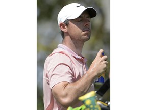 Rory McIlroy, of Northern Ireland, sprays himself with sunscreen after teeing off on the third hole during the third round of the Arnold Palmer Invitational golf tournament Saturday, March 9, 2019, in Orlando, Fla.