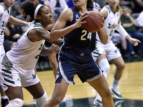 South Florida's Shae Leverett, left, defends against Connecticut's Napheesa Collier (24) during the second half of an NCAA basketball game Monday, March 4, 2019, in Tampa, Fla.