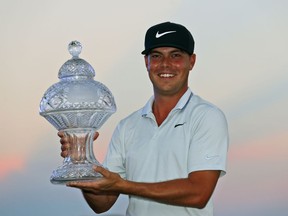 Keith Mitchell holds up his trophy after winning the Honda Classic golf tournament Sunday, March 3, 2019, in Palm Beach Gardens, Fla.