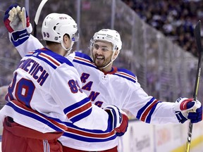 New York Rangers right wing Pavel Buchnevich (89) celebrates his goal with teammate Kevin Shattenkirk (22) during third period NHL hockey action against the Toronto Maple Leafs, in Toronto on Saturday, March 23, 2019.