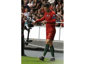 FILE - In this Monday, March 25, 2019 file photo, Portugal's Cristiano Ronaldo reacts during the Euro 2020 group B qualifying soccer match between Portugal and Serbia at the Luz stadium in Lisbon, Portugal. Juventus president Andrea Agnelli has hinted that the Bianconeri might not risk Cristiano Ronaldo for the first match of the Champions League quarterfinals against Ajax. Ronaldo injured a muscle in his right thigh and was forced off after half an hour of Portugal's 1-1 draw against Serbia in qualifying for the 2020 European Championship on Monday.