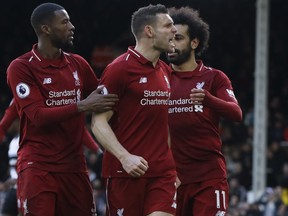 Liverpool's James Milner, center, celebrates after scoring his side's second goal, during the English Premier League soccer match between Fulham and Liverpool at Craven Cottage stadium in London, Sunday, March 17, 2019.