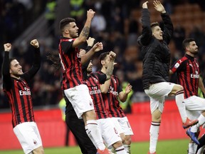 AC Milan players celebrate their 1-0 win at the end of the Serie A soccer match between AC Milan and Sassuolo, at the San Siro stadium in Milan, Italy, Saturday, March 2, 2019.
