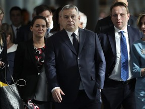 Hungarian Prime Minister Viktor Orban, center, arrives to an European People's Party's meeting at the European Parliament in Brussels, Wednesday, March 20, 2019. Hungary's ruling Fidesz party will immediately leave the main center-right alliance in the European Parliament if the group votes to suspend it, the Hungarian prime minister's chief of staff said Wednesday.