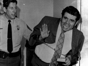 File - In this Feb. 5, 1973 file photo, convicted mass slayer Juan Corona waves to supporters as he leaves the Solano County Hall of Justice in Fairfield, Calif., after being sentenced to 25 consecutive life terms. California State Prison-Corcoran inmate Corona, 85, died of natural causes on Monday, March 4, 2019, at an outside hospital. Corona was serving 25 concurrent life sentences for 25 counts of first-degree murder. His victims were all farm workers. (AP Photo/File)
