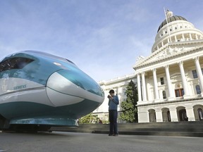 FILE - In this Feb. 26, 2015, file photo, a full-scale mock-up of a high-speed train is displayed at the Capitol in Sacramento, Calif. Leaders of California's high-speed rail project are telling the Trump administration its plans to withhold or claw back $3.5 billion in federal money for the project is "legally indefensible" and "disastrous policy." Project chief executive Brian Kelly responded Monday, March 4, 2019, to the U.S. Department of Transportation's threat last month to withhold a $929 million federal grant and explore taking back $2.5 billion in federal money the state has already spent.