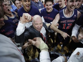 FILE - In this March 12, 2019, file photo, St. Mary's head coach Randy Bennett celebrates with his team after they defeated Gonzaga 60-47 in an NCAA college basketball game in the championship of the West Coast Conference tournament in Las Vegas. In all of his successful years at tiny Saint Mary's College and the challenge of turning around a program almost two decades ago, this NCAA Tournament berth is perhaps the most gratifying yet for Bennett.