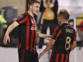 Atlanta United midfielder Julian Gressel, left, celebrates his goal against Herediano with Esequiel Barco during a CONCACAF Champions League soccer match Thursday, Feb. 28, 2018, in Kennesaw, Ga.