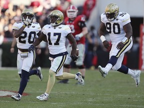 FILE - In this Nov. 26, 2016, file photo, Georgia Tech defensive back Lance Austin (17), Lawrence Austin (20) and Brandon Adams (90) celebrate after Austin intercepted a Georgia pass during an NCAA college football game in Athens, Ga. Adams has died at the age of 21. The school announced player's death Sunday, March 24, 2019. No cause was given.