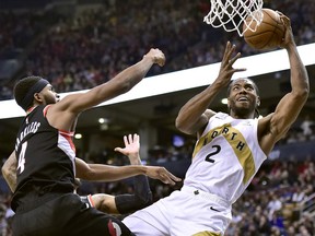 Toronto Raptors forward Kawhi Leonard (2) reaches for the hoop as Portland Trail Blazers forward Maurice Harkless (4) defends during second half NBA basketball action in Toronto on Friday, March 1, 2019.