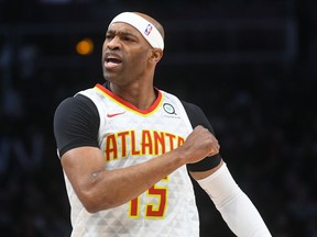 Atlanta Hawks forward Vince Carter reacts after making a three-point basket during the first half of an NBA basketball game against the Utah Jazz, Thursday, March 21, 2019, in Atlanta.