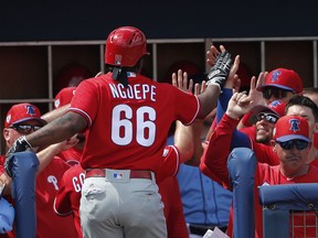 Philadelphia Phillies' Gift Ngoepe (66) celebrates at the dugout entrance after hitting a two-run home run in the seventh inning of a spring training baseball game against the Tampa Bay Rays Thursday, March 14, 2019, in Port Charlotte, Fla. Philadelphia won 4-3.
