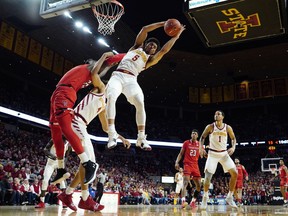 Iowa State guard Lindell Wigginton (5) grabs a rebound over Texas Tech center Norense Odiase, left, during the first half of an NCAA college basketball game, Saturday, March 9, 2019, in Ames, Iowa.