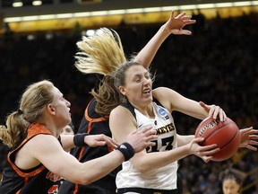 Iowa forward Amanda Ollinger, right, fights for a rebound with Mercer forward Amanda Thompson, left, during a first-round game in the NCAA women's college basketball tournament, Friday, March 22, 2019, in Iowa City, Iowa.