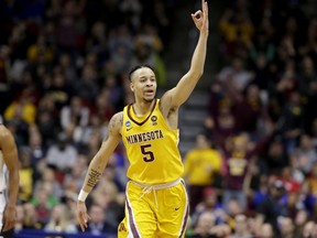 Minnesota's Amir Coffey (5) celebrates a three-point basket during the first half of a first round men's college basketball game against Louisville in the NCAA Tournament, in Des Moines, Iowa, Thursday, March 21, 2019.