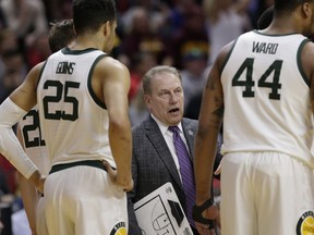 Michigan State coach Tom Izzo, center, talks to his players during a timeout in the first half of a first round men's college basketball game against Bradley in the NCAA Tournament in Des Moines, Iowa, Thursday, March 21, 2019.