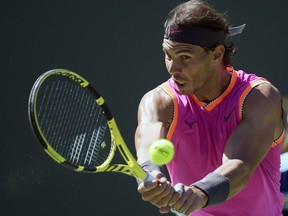 Rafael Nadal, of Spain, returns a shot to Filip Krajinovic, of Serbia, at the BNP Paribas Open tennis tournament Wednesday, March 13, 2019, in Indian Wells, Calif.