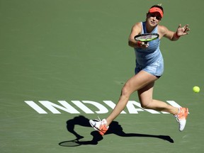 Belinda Bencic, of Switzerland, returns a shot to Karolina Pliskova, of the Czech Republic, at the BNP Paribas Open tennis tournament Thursday, March 14, 2019, in Indian Wells, Calif.