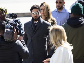 "Empire" actor Jussie Smollett, center, arrives at Leighton Criminal Court Building for a hearing to discuss whether cameras will be allowed in the courtroom during his disorderly conduct case on Tuesday, March 12, 2019, in Chicago. A grand jury indicted Smollett last week on 16 felony counts accusing him of lying to the police about being the victim of a racist and homophobic attack by two masked men in downtown Chicago.