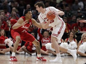 Wisconsin's Nate Reuvers (35) drives against Nebraska's James Palmer Jr. (0) during the first half of an NCAA college basketball game in the quarterfinals of the Big Ten Conference tournament, Friday, March 15, 2019, in Chicago.