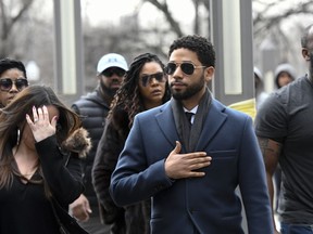 Empire actor Jussie Smollett, center, arrives at the Leighton Criminal Court Building for his hearing on Thursday, March 14, 2019, in Chicago. Smollett is accused of lying to police about being the victim of a racist and homophobic attack by two men on Jan. 29 in downtown Chicago.