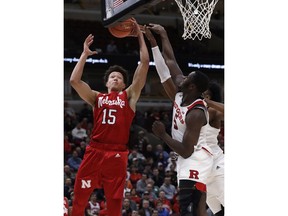 Nebraska forward Isaiah Roby, left, drives to the basket against Rutgers forward Eugene Omoruyi, center, and center Myles Johnson during the first half of an NCAA college basketball game in the first round of the Big Ten Conference tournament in Chicago, Wednesday, March 13, 2019.