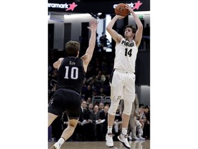 Purdue guard Ryan Cline, right, shoots against Northwestern forward Miller Kopp during the first half of an NCAA college basketball game Saturday, March 9, 2019, in Evanston, Ill.