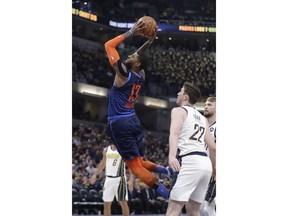 Oklahoma City Thunder's Paul George (13) goes up for a dunk against Indiana Pacers' T.J. Leaf (22) during the first half of an NBA basketball game, Thursday, March 14, 2019, in Indianapolis.