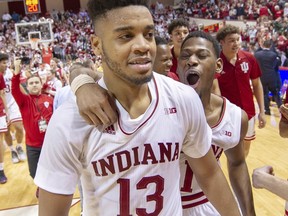 Indiana forward Juwan Morgan (13) and guard Aljami Durham (1) celebrate on the court after defeating Michigan State in an NCAA college basketball game, Saturday, March 2, 2019, in Bloomington, Ind. Indiana won 63-62.