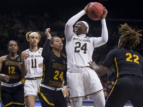 Notre Dame's Arike Ogunbowale (24) goes up for a shot between Bethune-Cookman's Angel Golden (24) and Tania White (22) during a first-round game in the NCAA women's college basketball tournament in South Bend, Ind., Saturday, March 23, 2019.