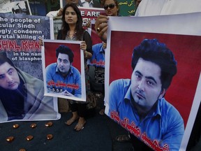 FILE - In this April 22, 2017 file photo, members of a Pakistani civil society group demonstrate against the killing of university student Mashal Khan, in Karachi, Pakistan. A court in northwest Pakistan sentenced two men to life in prison after they were found guilty of involvement in the death of Khan, a university student who was beaten and eventually shot to death by a mob after he was falsely accused of blasphemy.