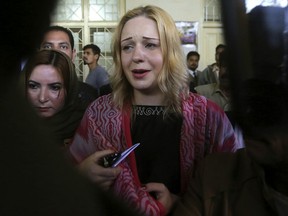 Czech model Tereza Hluskova, center, reacts after appearing in court in Lahore, Pakistan, Wednesday, March 20, 2019. A Pakistani court sentenced the 22-year-old Czech model to eight years and eight months in jail after she was found guilty of drug trafficking. According to the court, Hluskova was arrested in possession of 8.5 kilograms, or 19 pounds, of heroin in January 2018 at the Lahore airport from where she was heading to Ireland via Dubai, the United Arab Emirates.