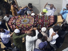 Mourners carry the casket of Syed Areeb Ahmed, a victim of the Christchurch mosque shootings, during his funeral in Karachi, Pakistan, Monday, March 25, 2019. Ahmed was among nine Pakistanis who were killed on March 15 when a white supremacist shot people inside two mosques in Christchurch, New Zealand.