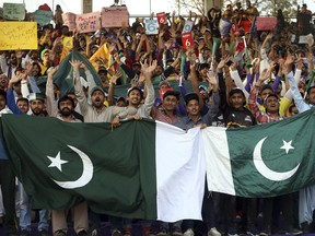 Cricket fans cheer before the start final cricket match of Pakistan Super League at National stadium in Karachi, Pakistan, Sunday, March 17, 2019.