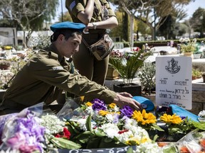 Israeli soldiers and friends of Staff Sgt. Gal Keidan mourn at his grave after the funeral in the city of Beersheba, Monday, March 18, 2019. Keidan was killed by Palestinian assailant in the West Bank Sunday.