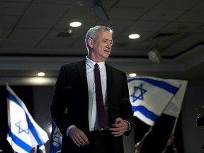 FILE - In this Wednesday, March 27, 2019 file photo, retired Israeli general Benny Gantz, one of the leaders of the Blue and White party, prepares to deliver a speech during election campaigning for elections to be held April 9, in Ramat Gan, Israel. Down in the polls, Israeli Prime Minister Benjamin Netanyahu's Likud Party has released a new campaign trying to paint Gantz, his main rival, as mentally unstable. The video ads are the latest move in a campaign that has been heavy on personal insults and short on substance.