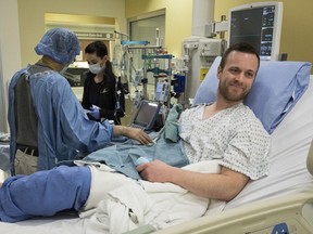 Josh McQuillin, right, of Prince George, B.C., who is the first Canadian in history to receive a direct intravenous injection gene replacement therapy, undergoes tests at the University of Calgary's clinical trials unit in Calgary, Alta., Thursday, March 14, 2019.